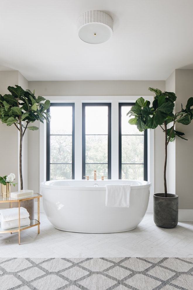 Modern Farmhouse master bathroom white tub and three windows