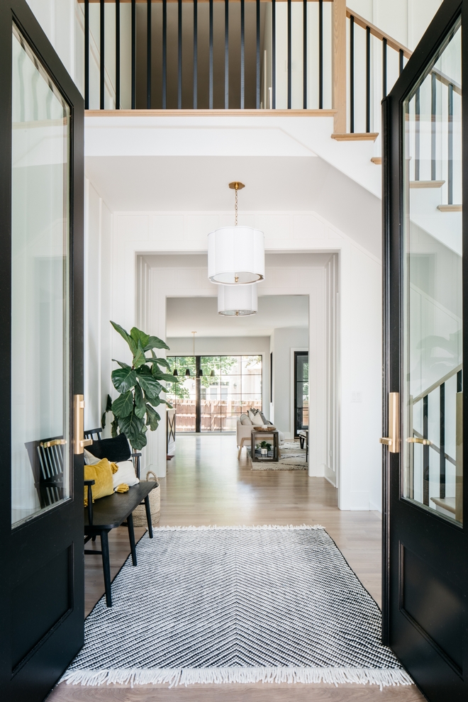 Double entryway doors black with view to rest of modern farmhouse