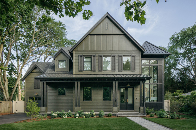 modern farmhouse exterior with dark paneling and metal roof