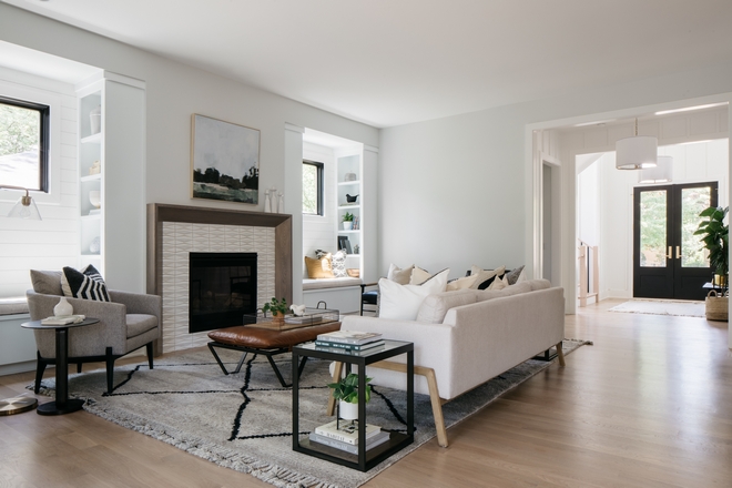 Open modern living room with fireplace and bookshelved bench seats