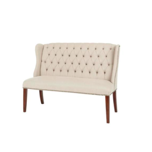 Cream colored tall backed dining bench upholstered with tufts