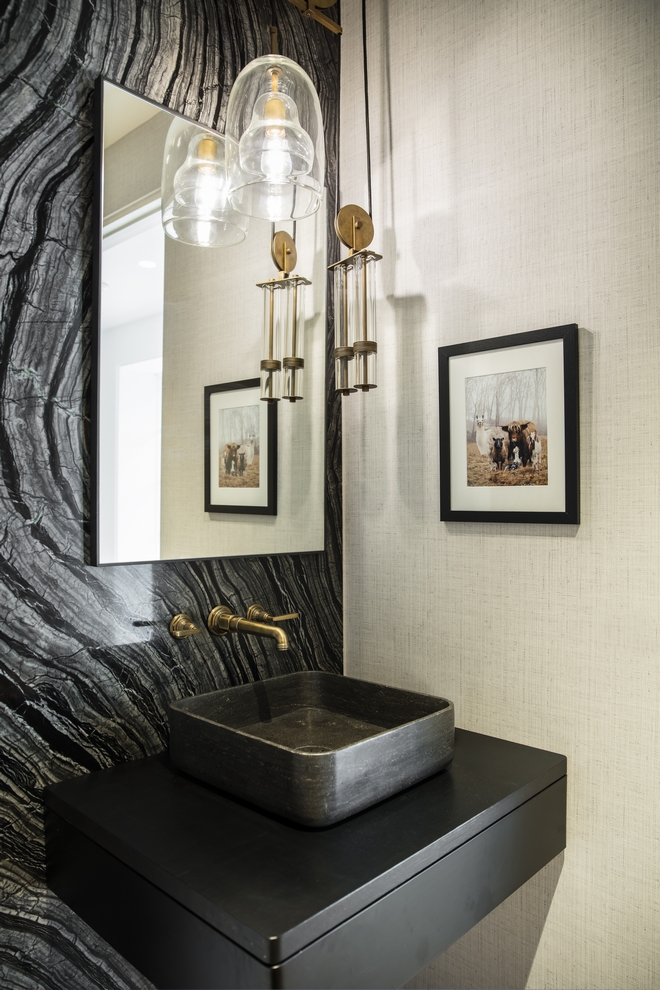 bathroom with styled dark wall and sink
