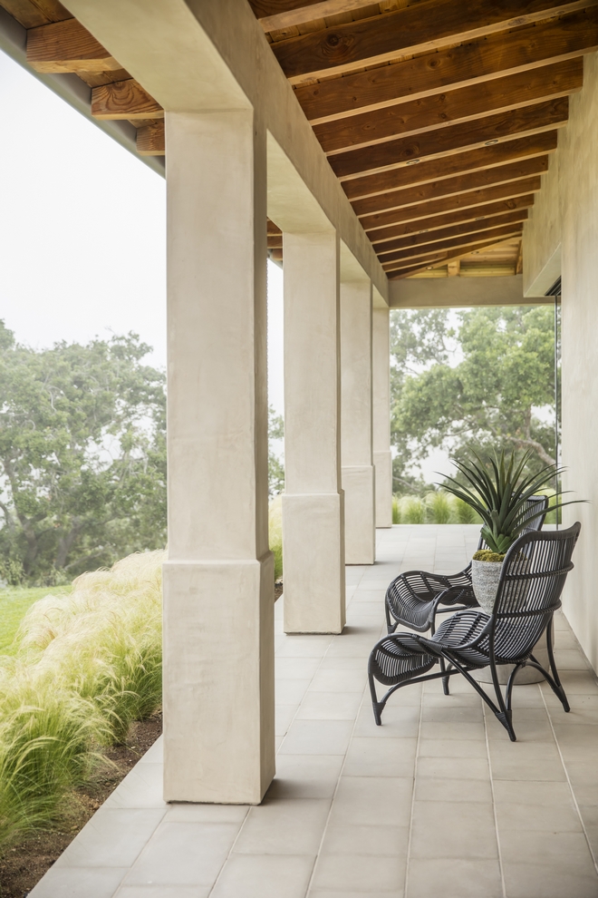 wraparound porch with wicker chairs and view over california countryside