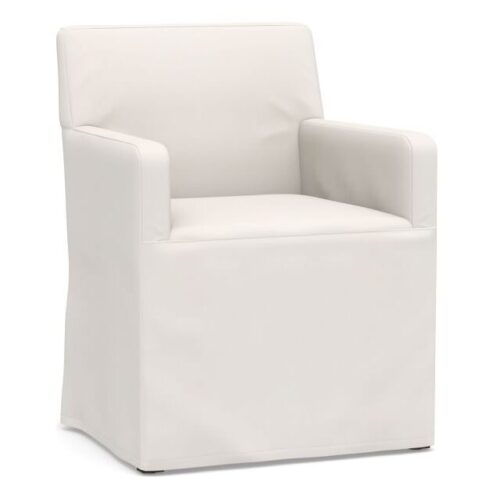 White slipcovered dining chair with arms