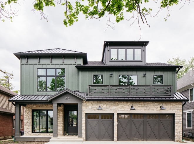 Two story modern farmhouse featuring light stone and green siding