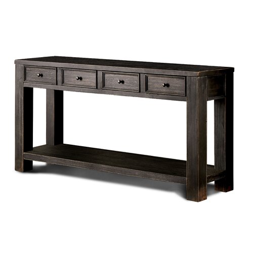 antique looking black wood console table with four shallow drawers on top. open centered