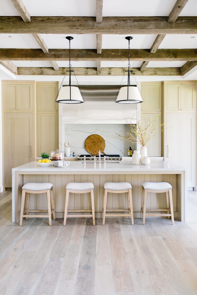 kitchen with white oak cabinets, quartz countertop and accents, and wood beam supports