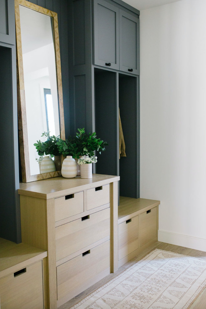mudroom with white oak cut-out handle drawers and dusty blue locker spaces.