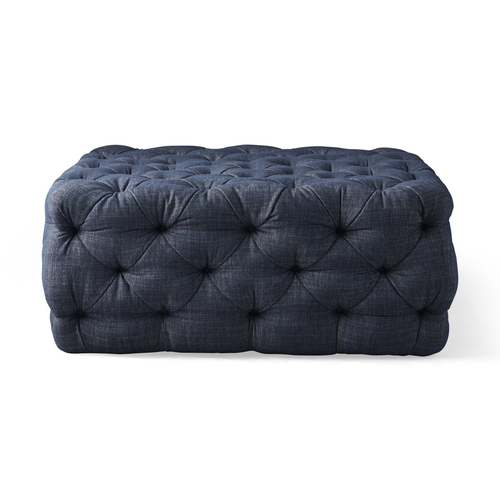 Navy upholstered and tufted square ottoman that rests directly on the ground